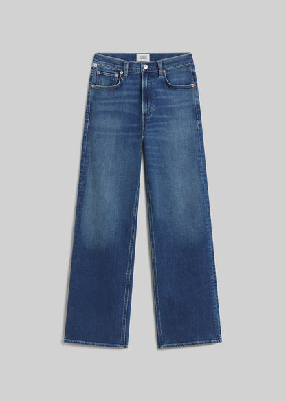 Medium indigo wide-leg jeans on grey background