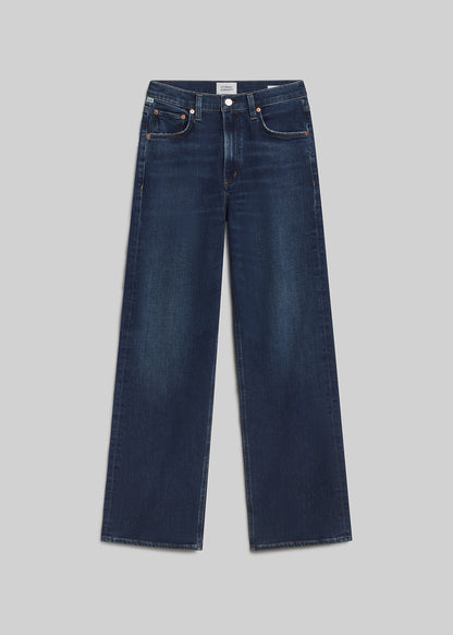 Dark indigo wide-leg jeans on grey background