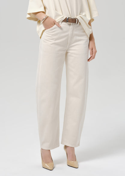 Close up shot of white pants and a brown belt on a grey background