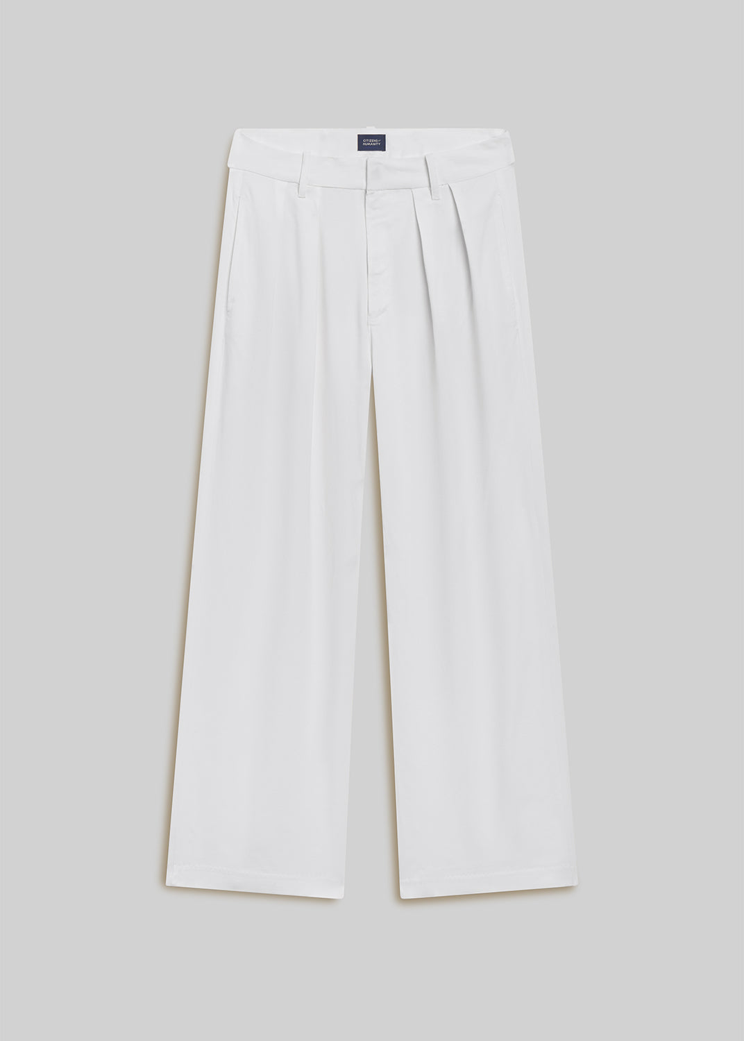 Winter white wool wide-leg trousers with front pleats, belt loops, side pockets, and a concealed front closure, front flat lay view on a grey background.