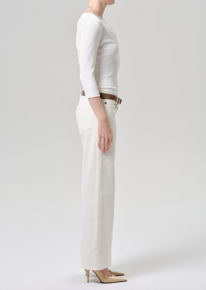 Person wearing a white outfit with a grey background