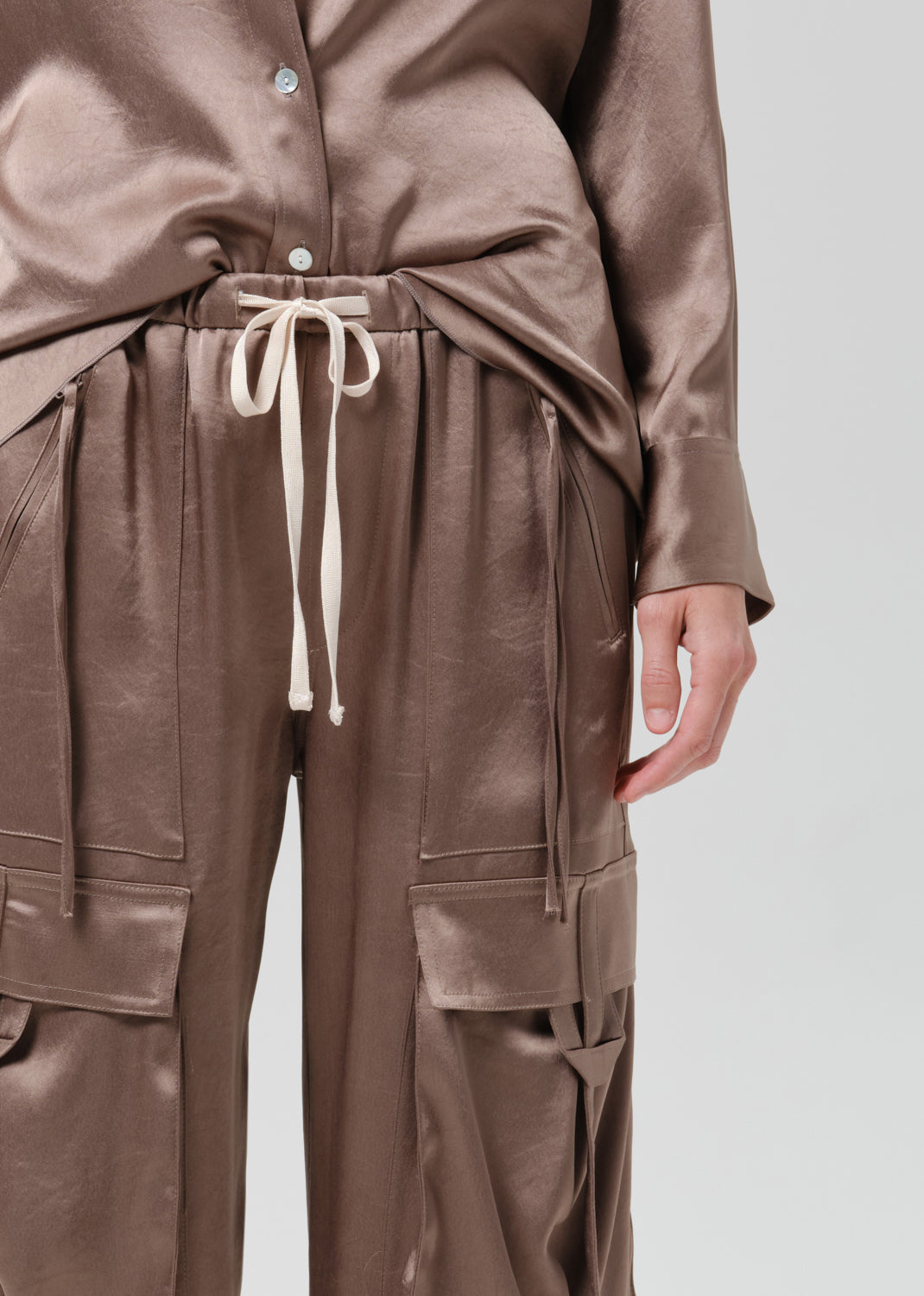 Close up of silk brown pants on a grey background