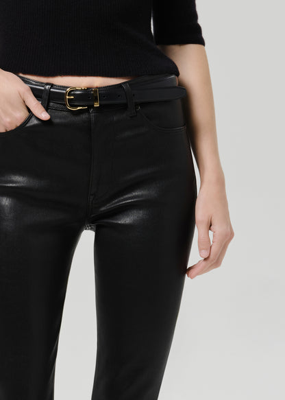 Close up shot of black leather pants on a grey background