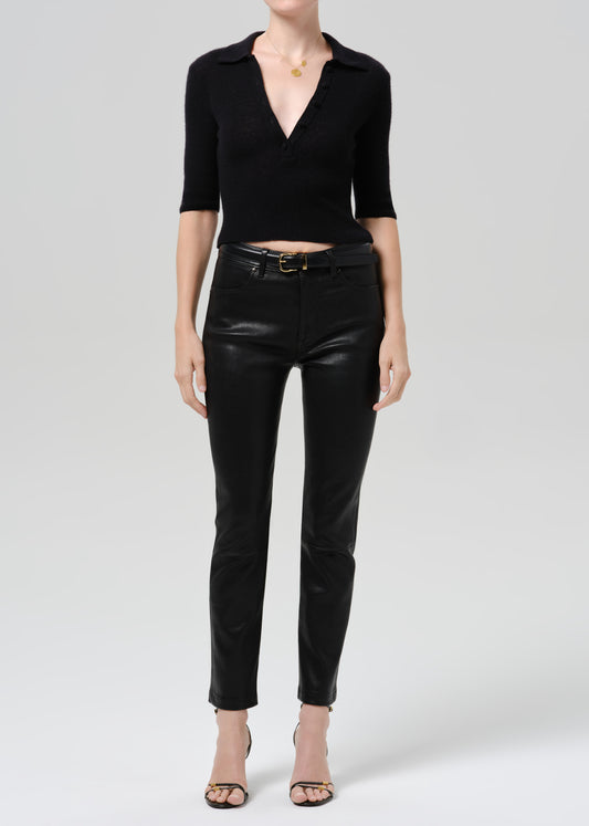Person wearing black outfit on a grey background