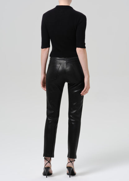 Person wearing black outfit on a grey background