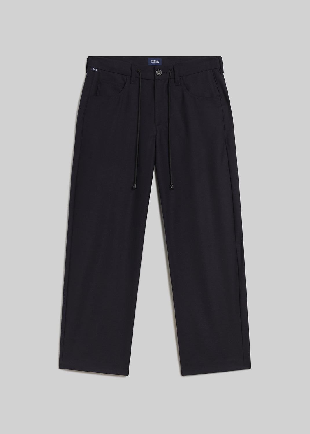 Navy drawstring trousers on grey background