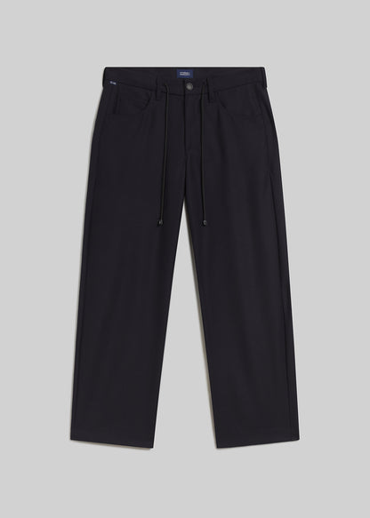 Navy drawstring trousers on grey background