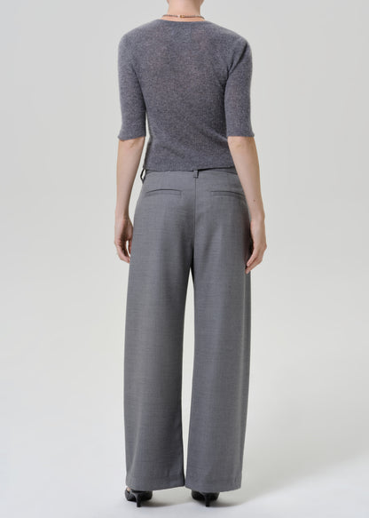A model shown from the back wearing a heathered gray three-quarter sleeve knit top and matching gray wide-leg trousers, photographed against a light gray studio background.