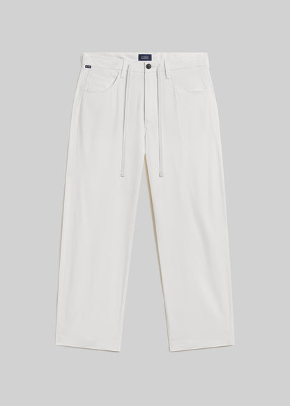 Winter white wide-leg wool trousers with a drawstring waistband, belt loops, front pockets, and button closure, front flat lay view on a grey background.