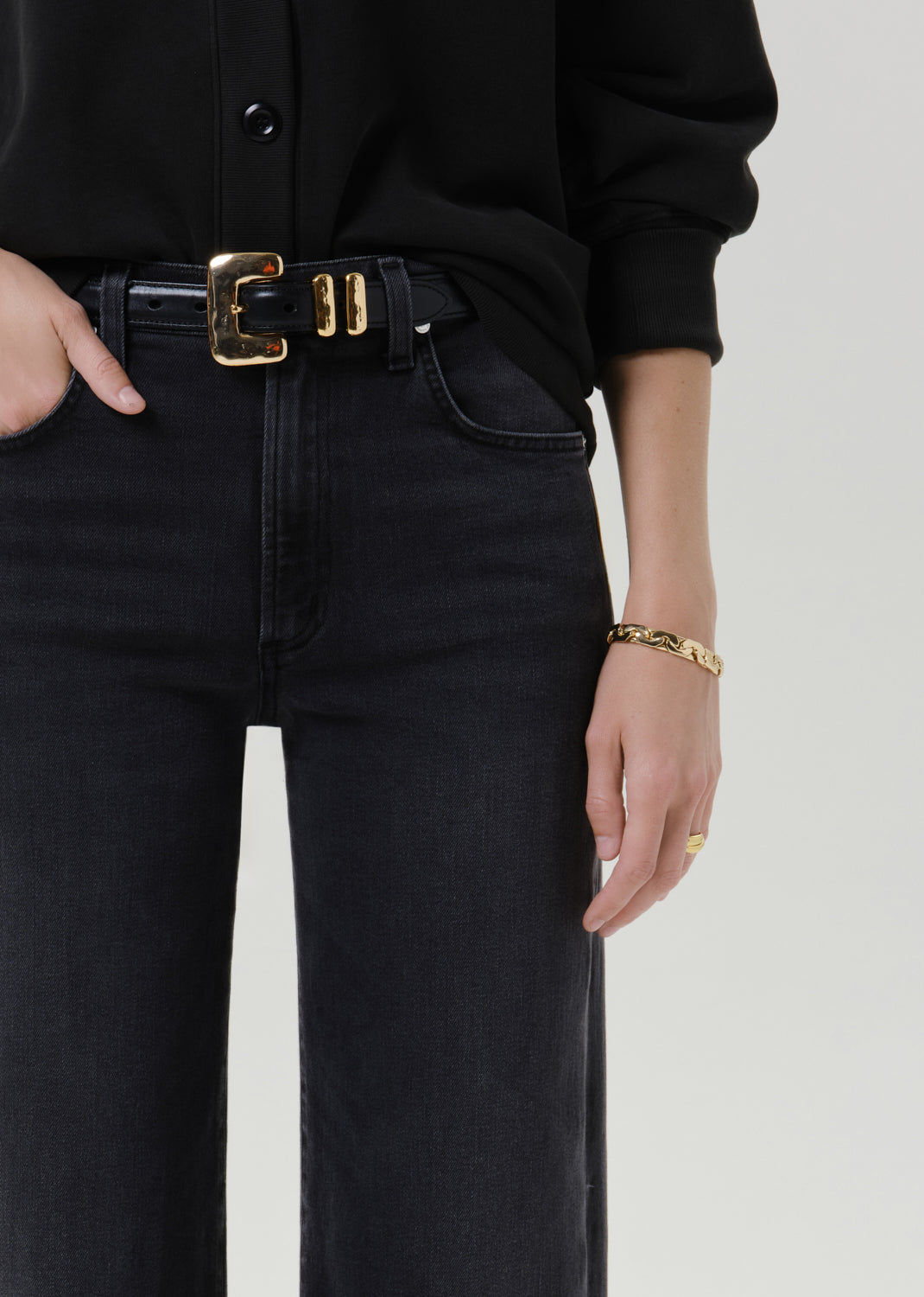 Close up shot of black pants on a grey background