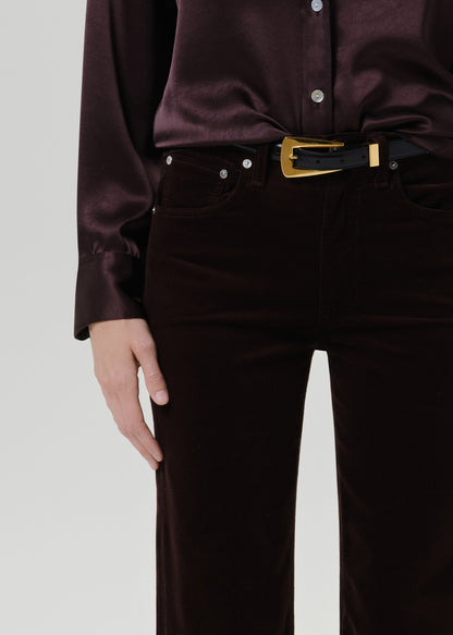 Close up shot of burgundy pants on a grey background