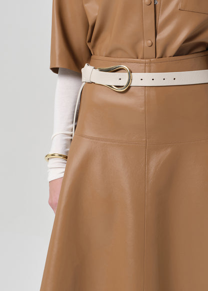Brown leather outfit with a belt worn by a person on a grey background