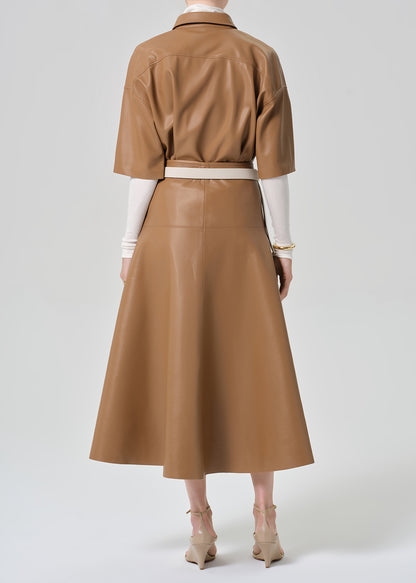 Brown leather outfit with a belt worn by a person on a grey background