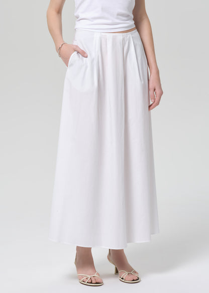 Person wearing a white skirt on a plain background