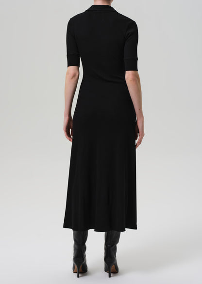 Black dress worn by a person on a grey background