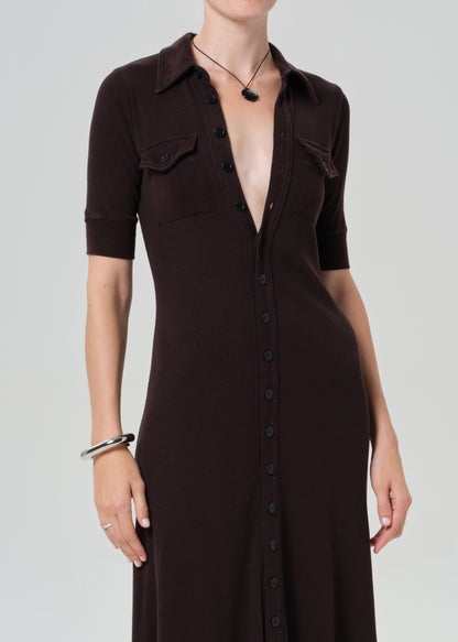 Woman wearing a brown dress on a grey background