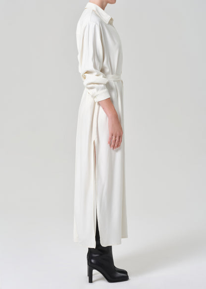 Person wearing a long white dress on a grey background