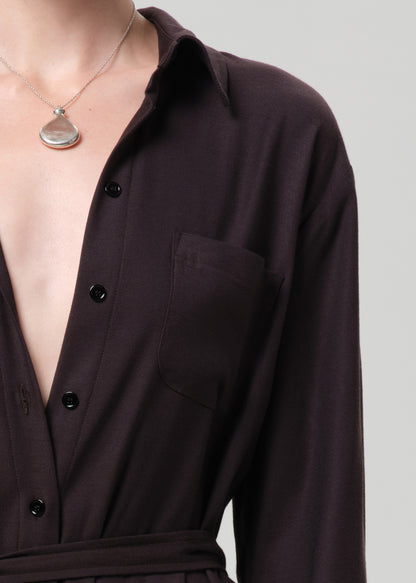 Brown dress with buttons on a grey background