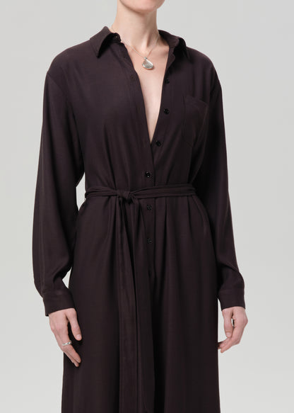 Dark brown dress with a belt on a grey background