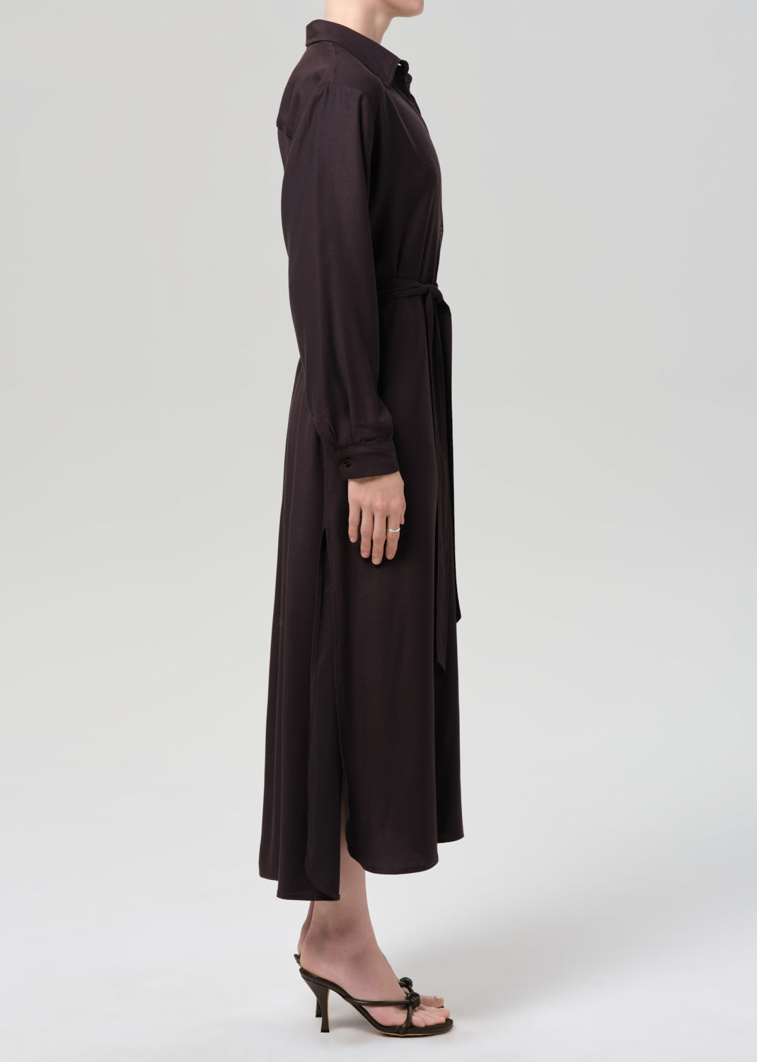 Brown dress worn by a person on a grey background