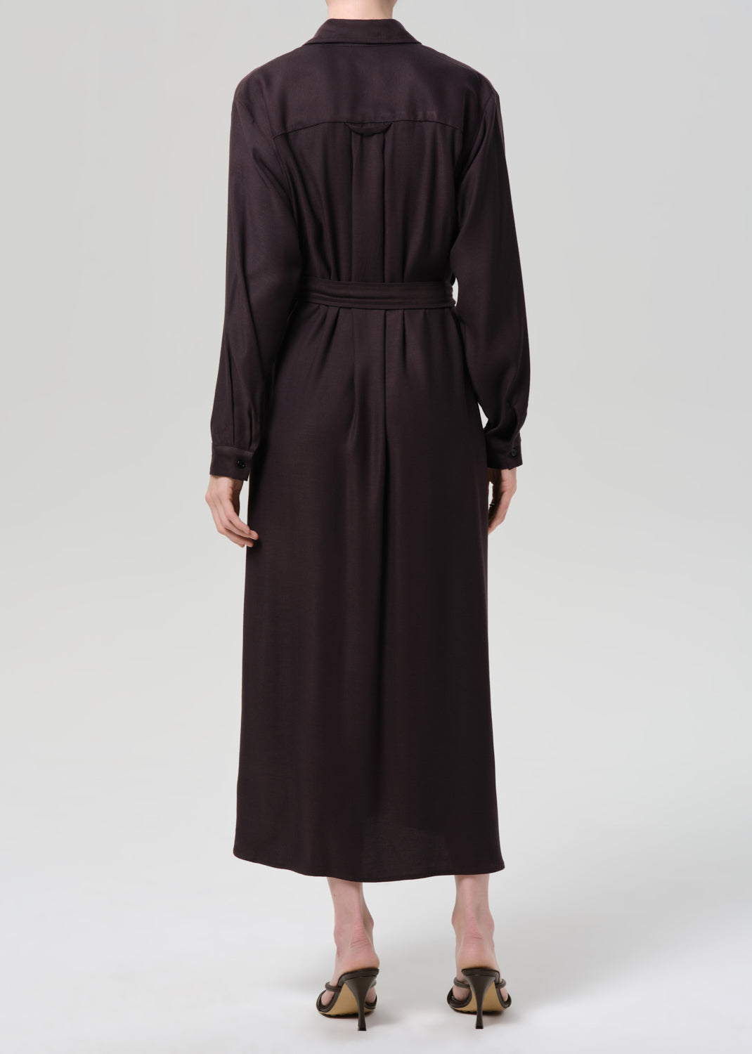 Dark brown dress with a belt on a grey background