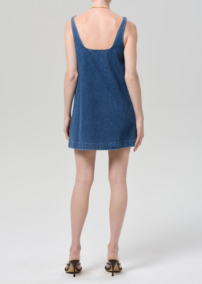 Blue denim dress worn by a person on a white background