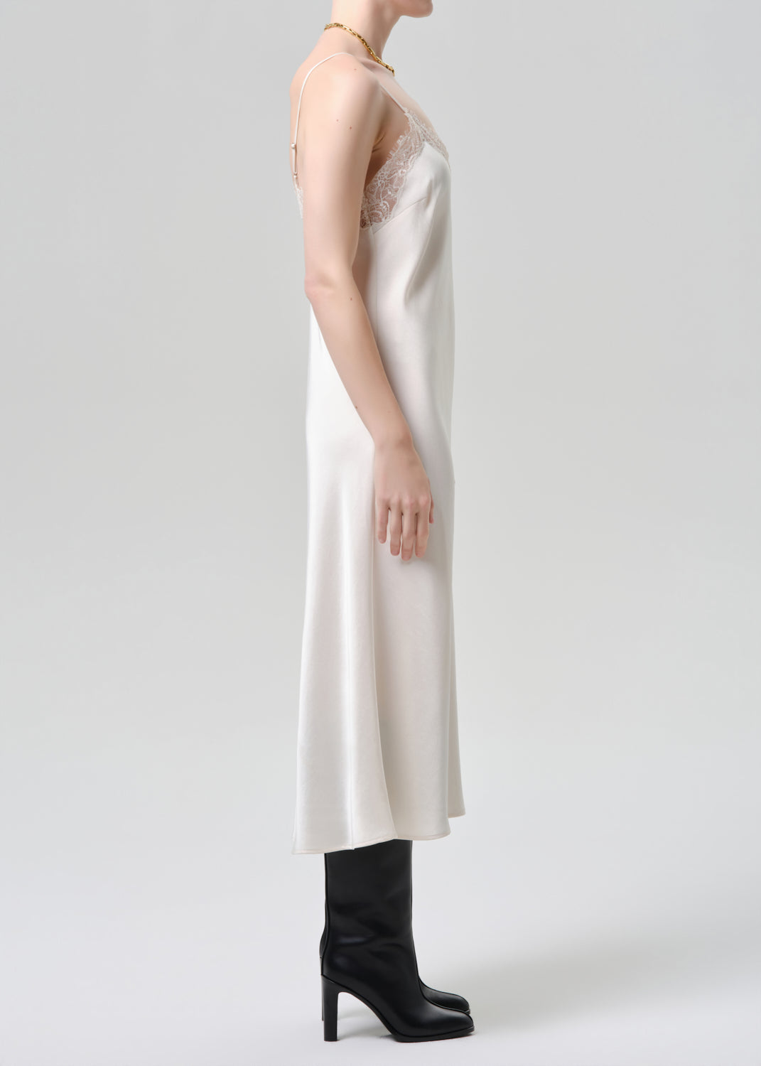 White dress worn by a mannequin on a grey background