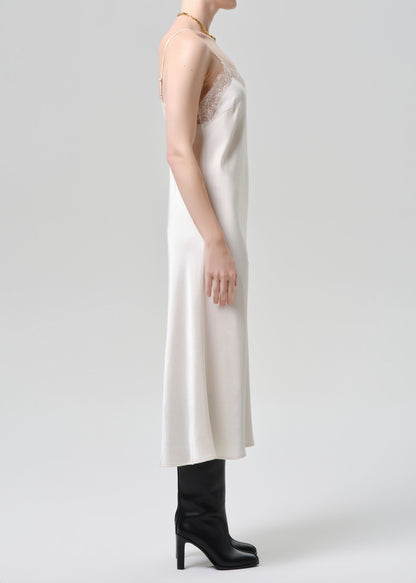 White dress worn by a mannequin on a grey background