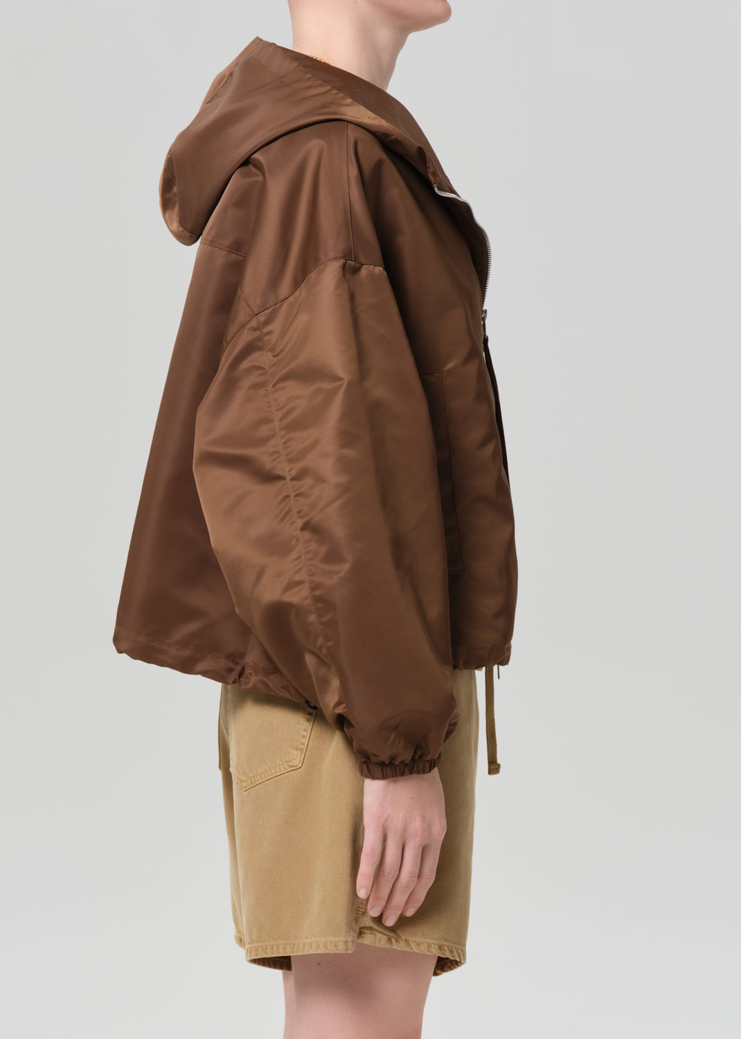 Brown jacket worn by a person on a plain background