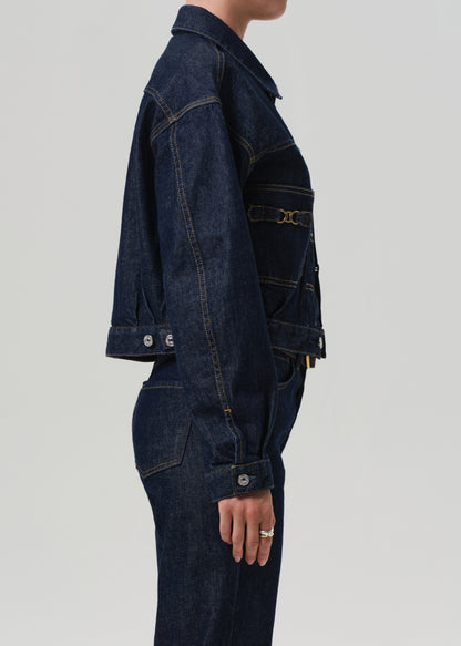 Dark denim jacket and pants on a plain background