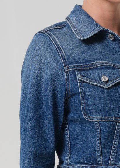 Close-up of a blue denim jacket on a plain background