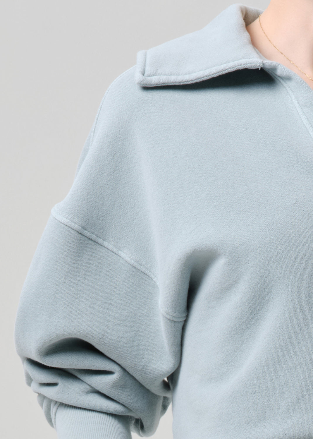 Light blue sweatshirt on a grey background