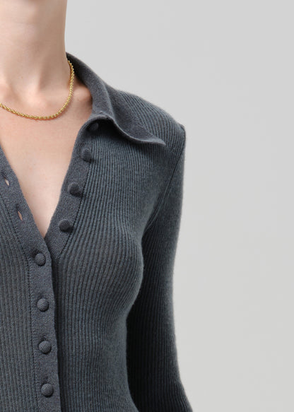 Close-up of a charcoal ribbed collared cardigan on a grey background