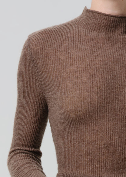 Brown ribbed sweater on a grey background