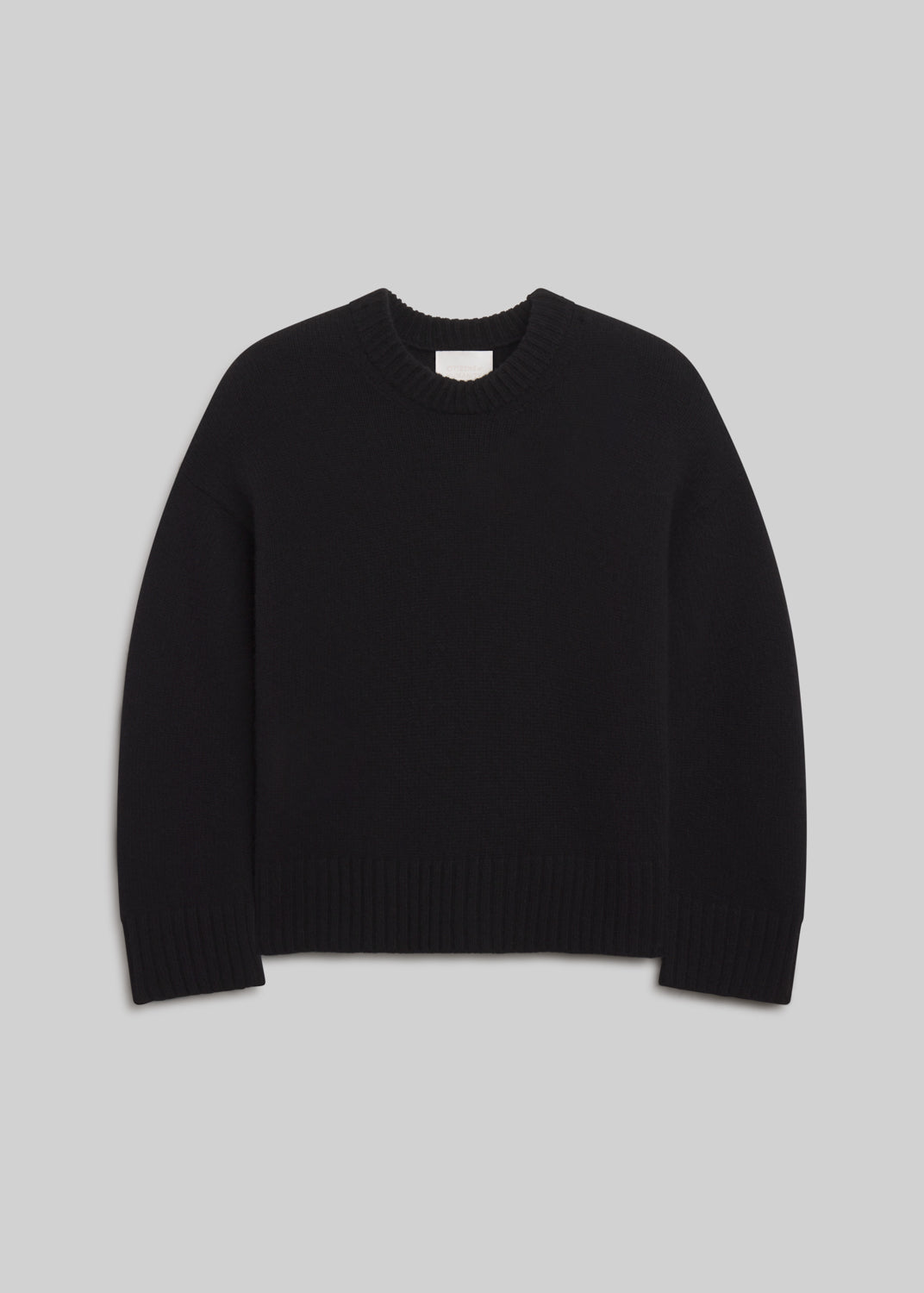 Freshman Crewneck Sweater in Black, featuring a relaxed silhouette, dropped shoulders, ribbed crew neckline, cuffs, and hem, front view on a grey background.