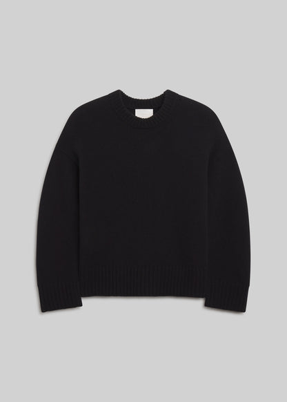 Freshman Crewneck Sweater in Black, featuring a relaxed silhouette, dropped shoulders, ribbed crew neckline, cuffs, and hem, front view on a grey background.