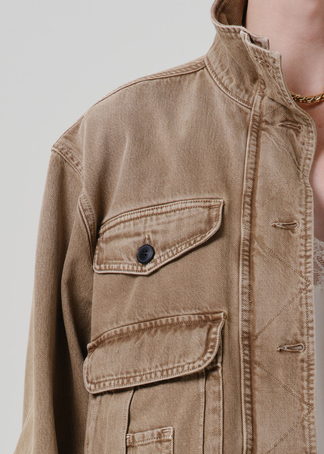 Close up of tan jacket on grey background