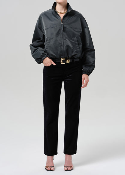 Person wearing dark green nylon jacket paired with black pants