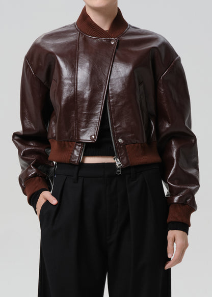 Dark red leather jacket worn by a person on a grey background