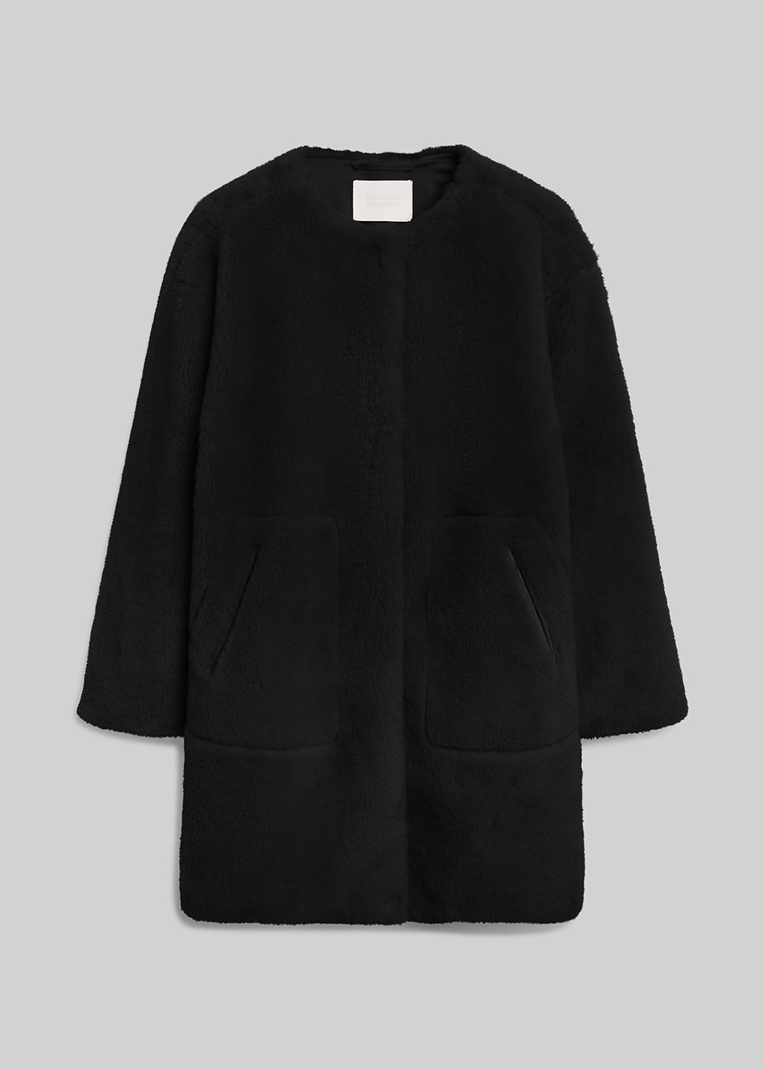 Black long sherpa coat with front pockets on grey background