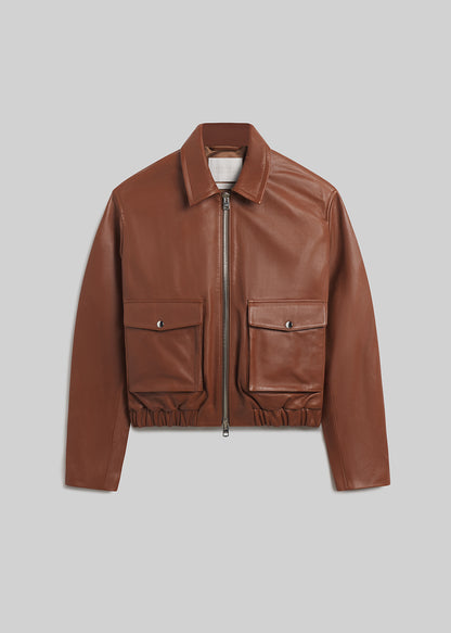 Praline brown leather zip-front bomber jacket with flap pockets on grey background