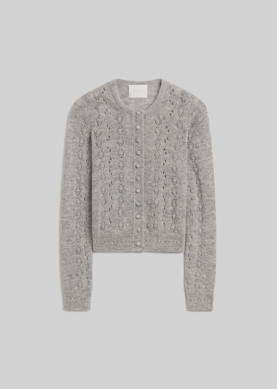 Heather grey pointelle knit button-front cardigan on grey background