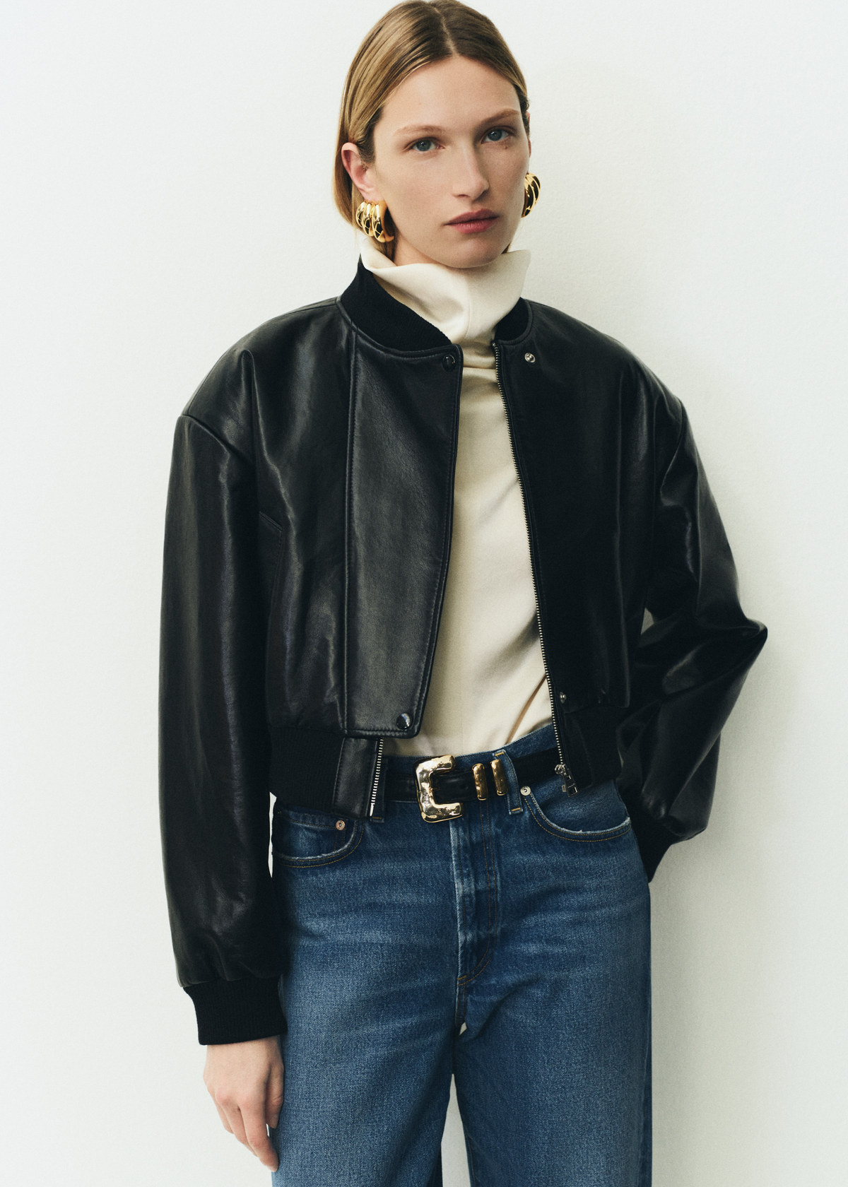 The Taper Jean in Pastis, Camille Moto Jacket in Black, Clara Draped Top in Cream.