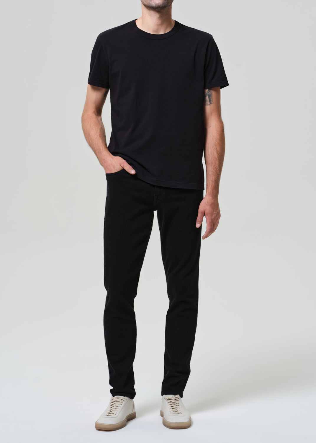 Person wearing a black t-shirt and black jeans