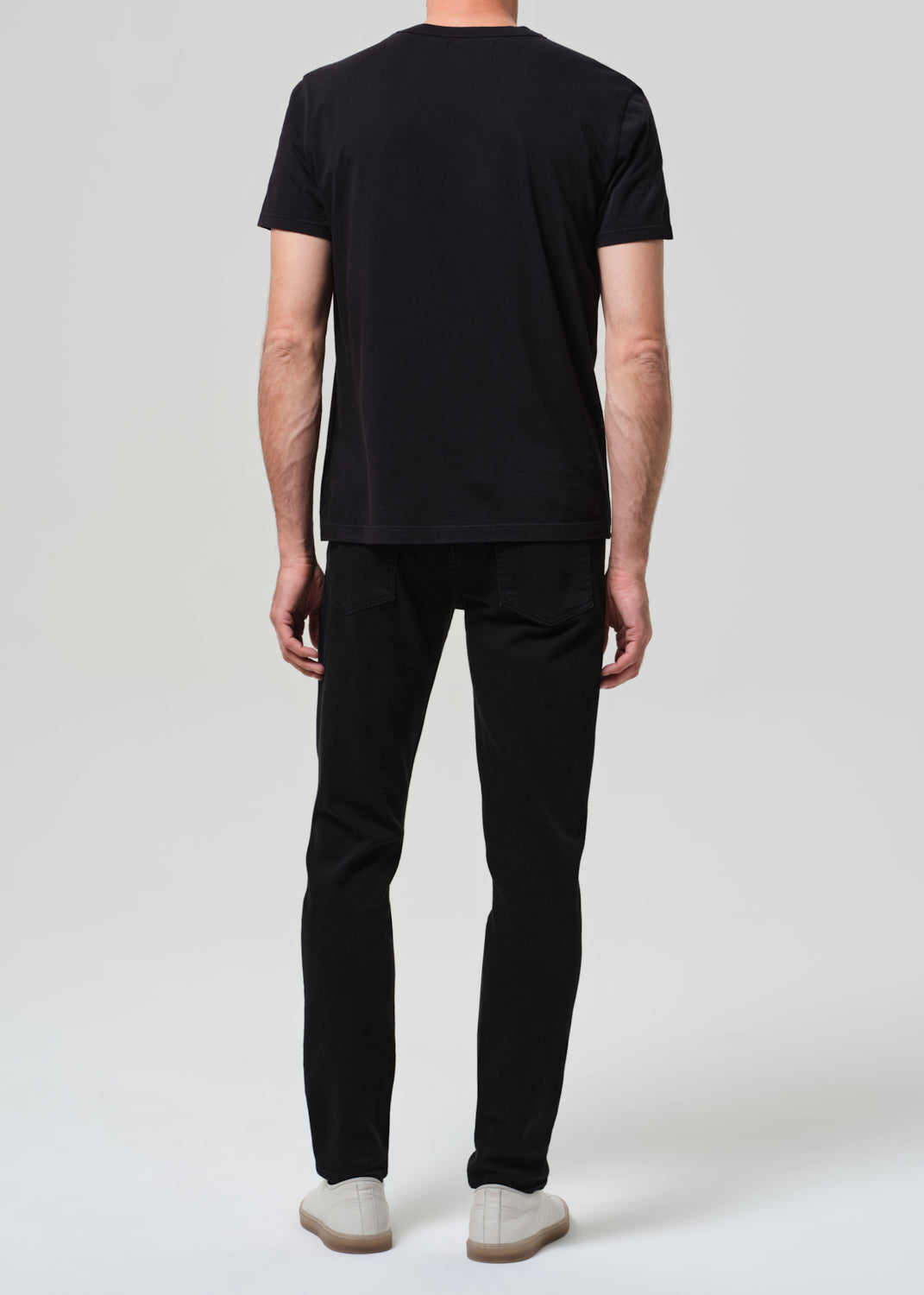 Person wearing a black t-shirt and black jeans