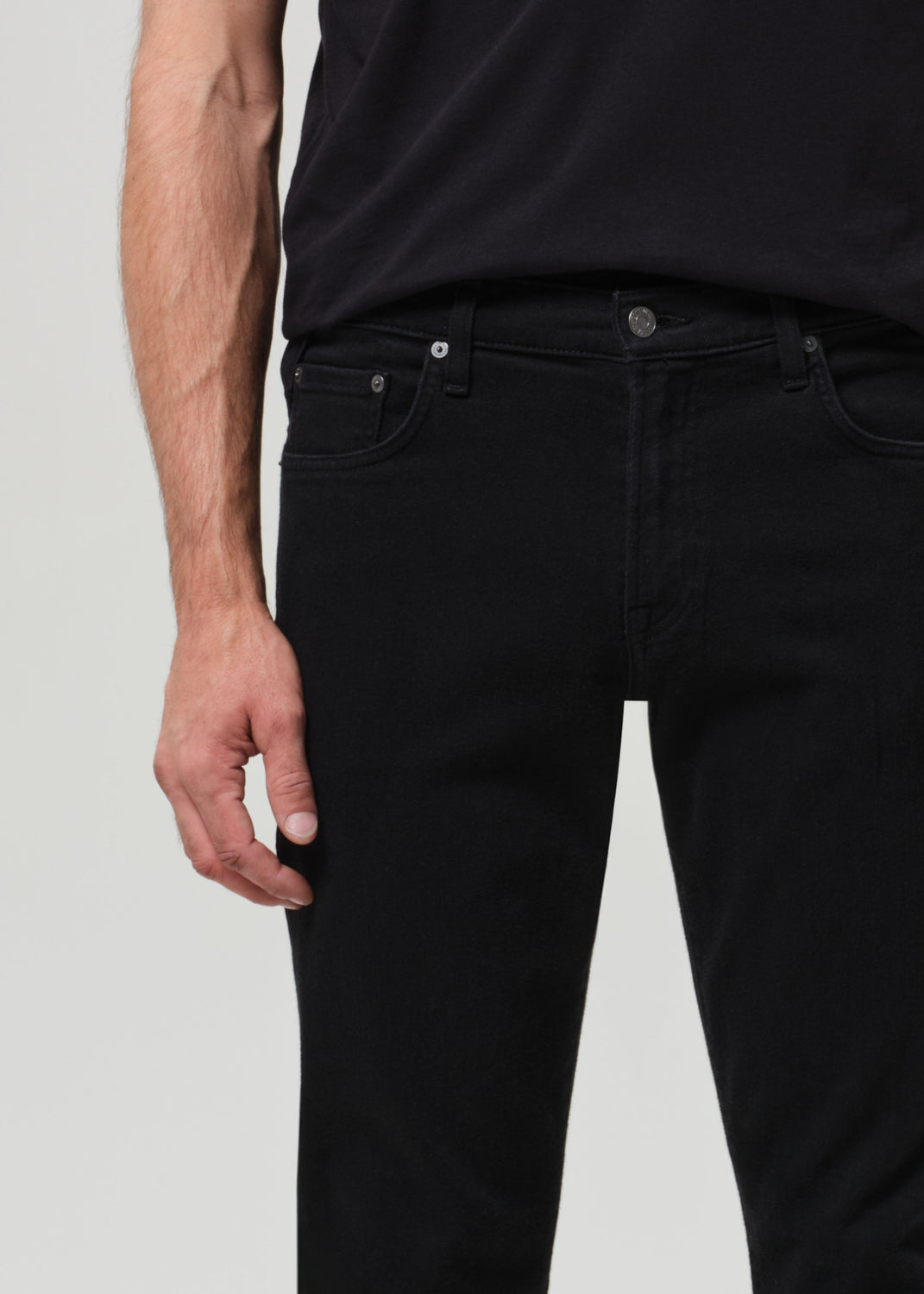 Person wearing a black t-shirt and black jeans