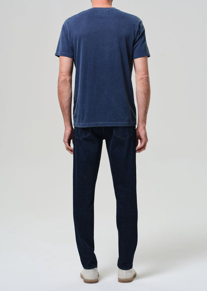 Person wearing a blue t-shirt and dark jeans