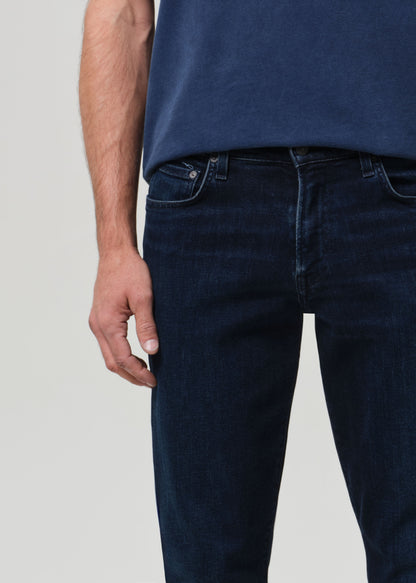 Person wearing a blue t-shirt and dark jeans