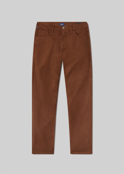 Flat lay of a brownish orange pant on a grey background.