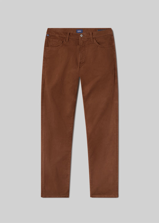 Flat lay of a brownish orange pant on a grey background.